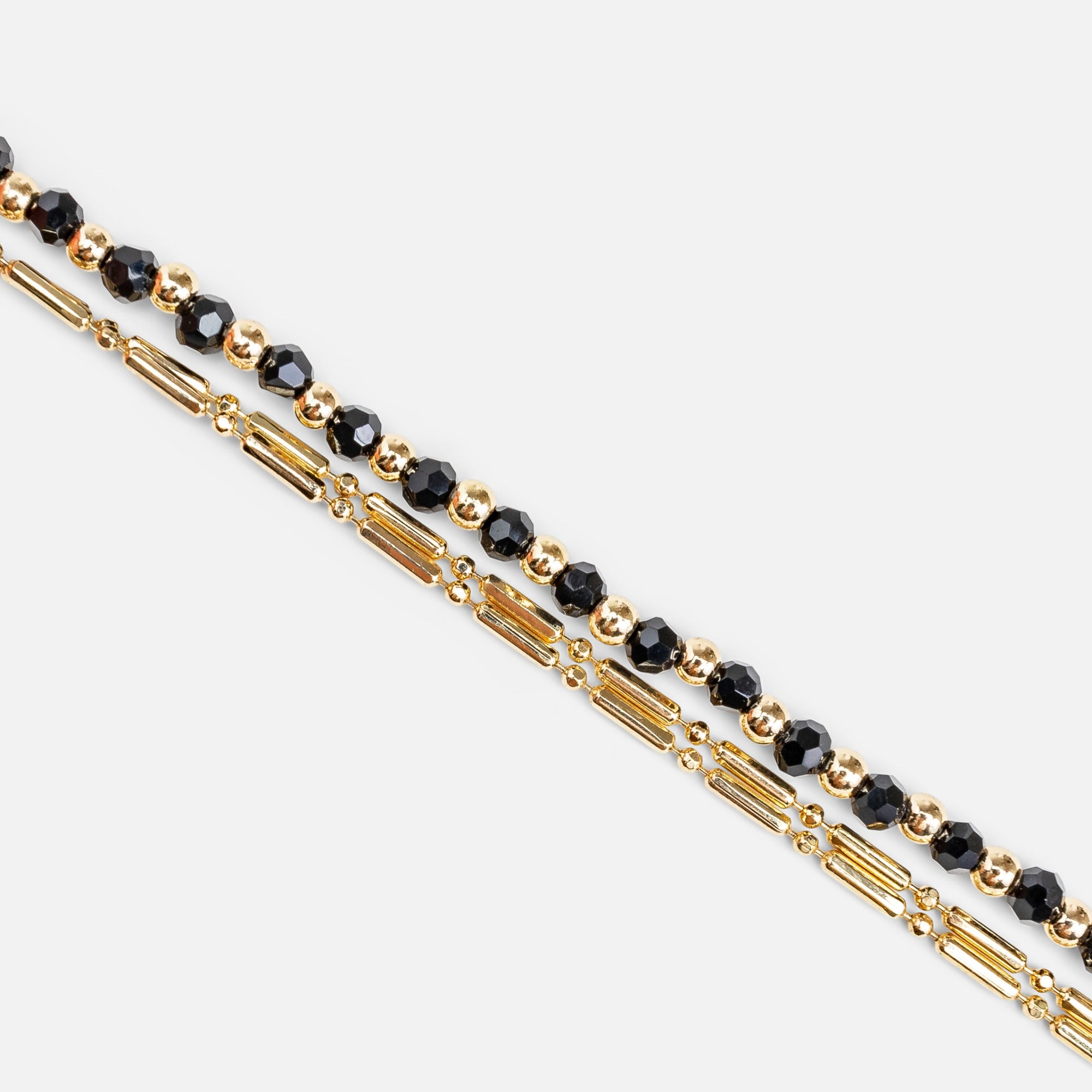Bracelet double chaînes dorées et noires avec breloques