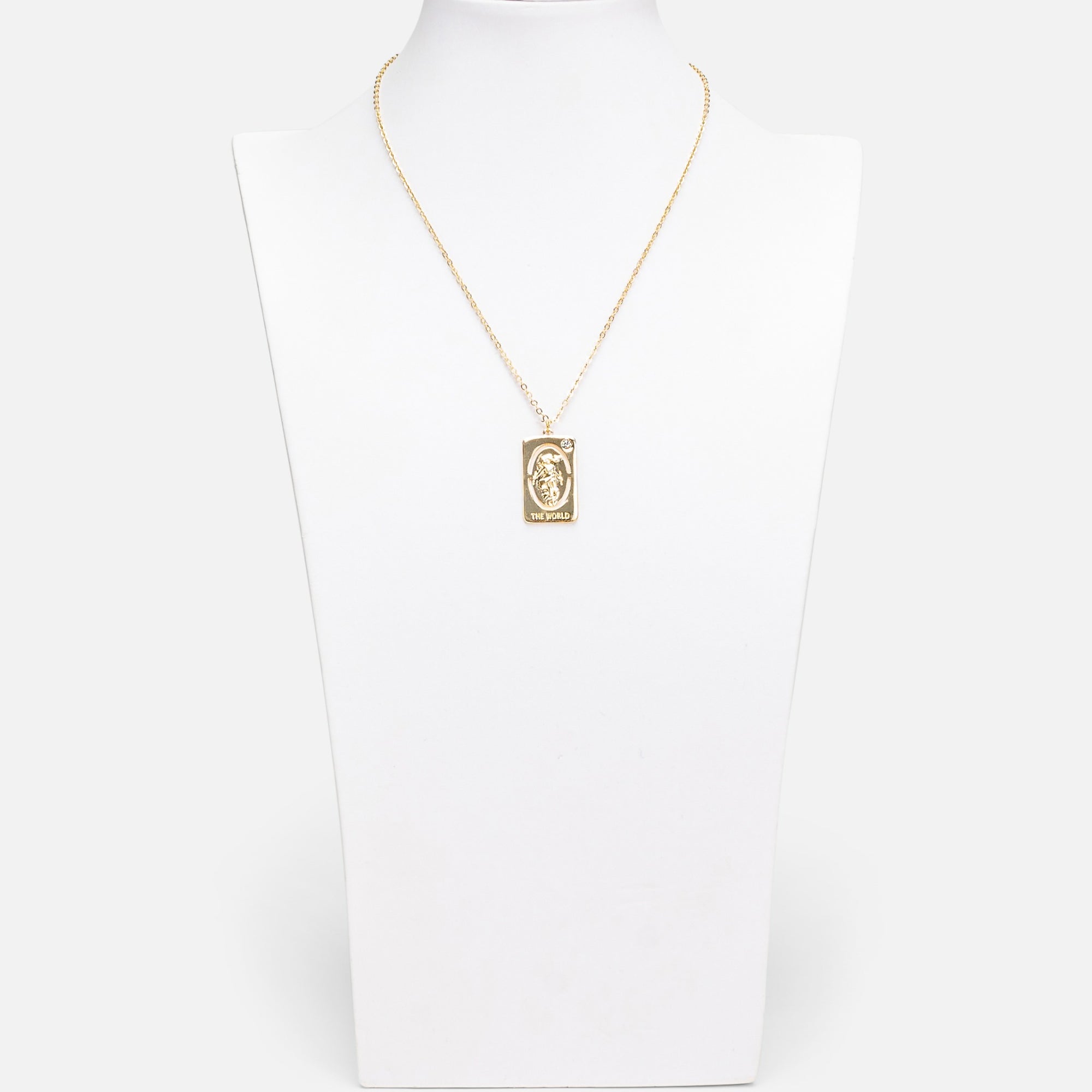 Golden pendant with world tarot card