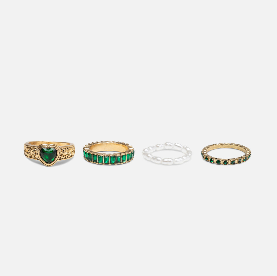 Set of four golden rings with emerald stones and pearls