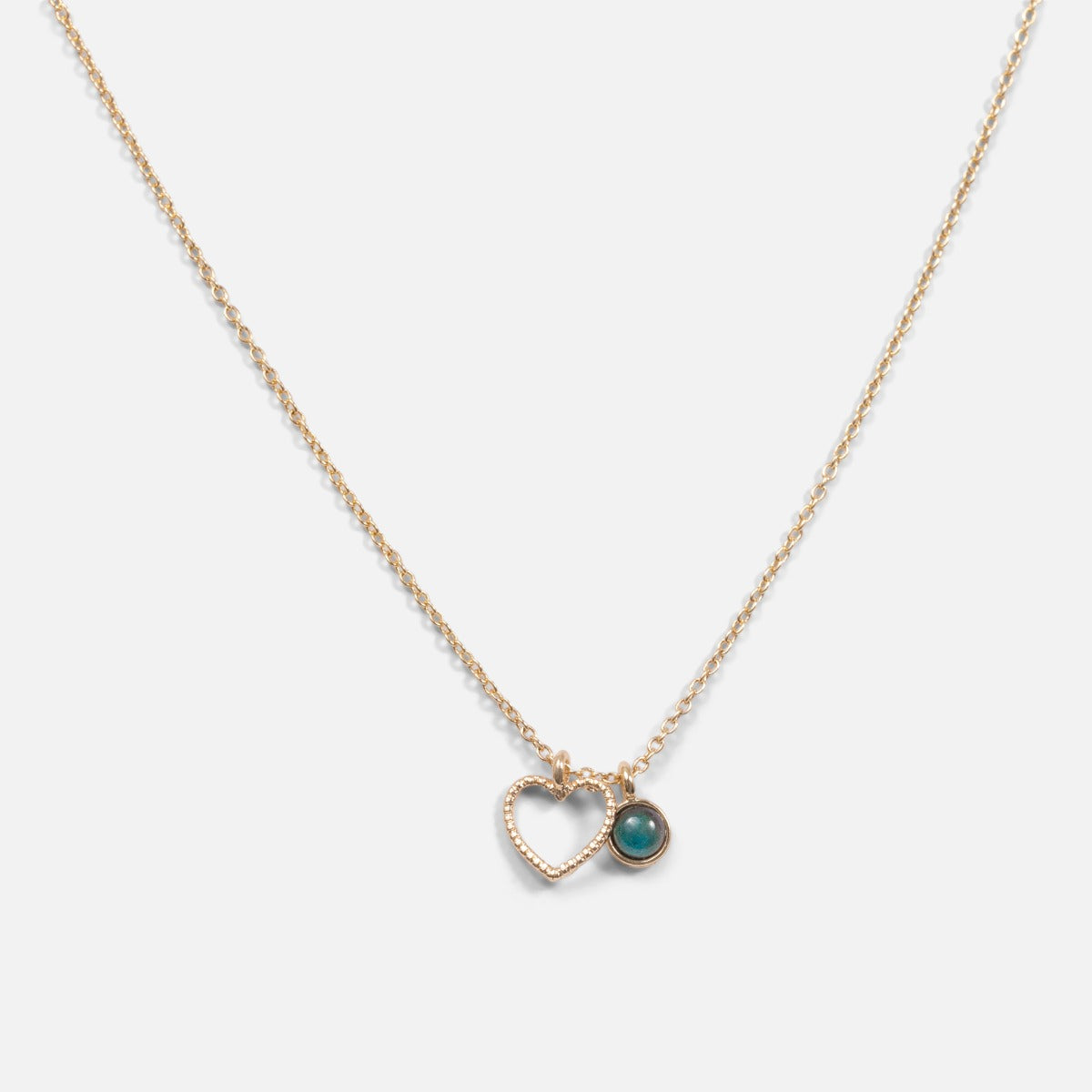 Golden pendant with openwork heart charm and turquoise stone