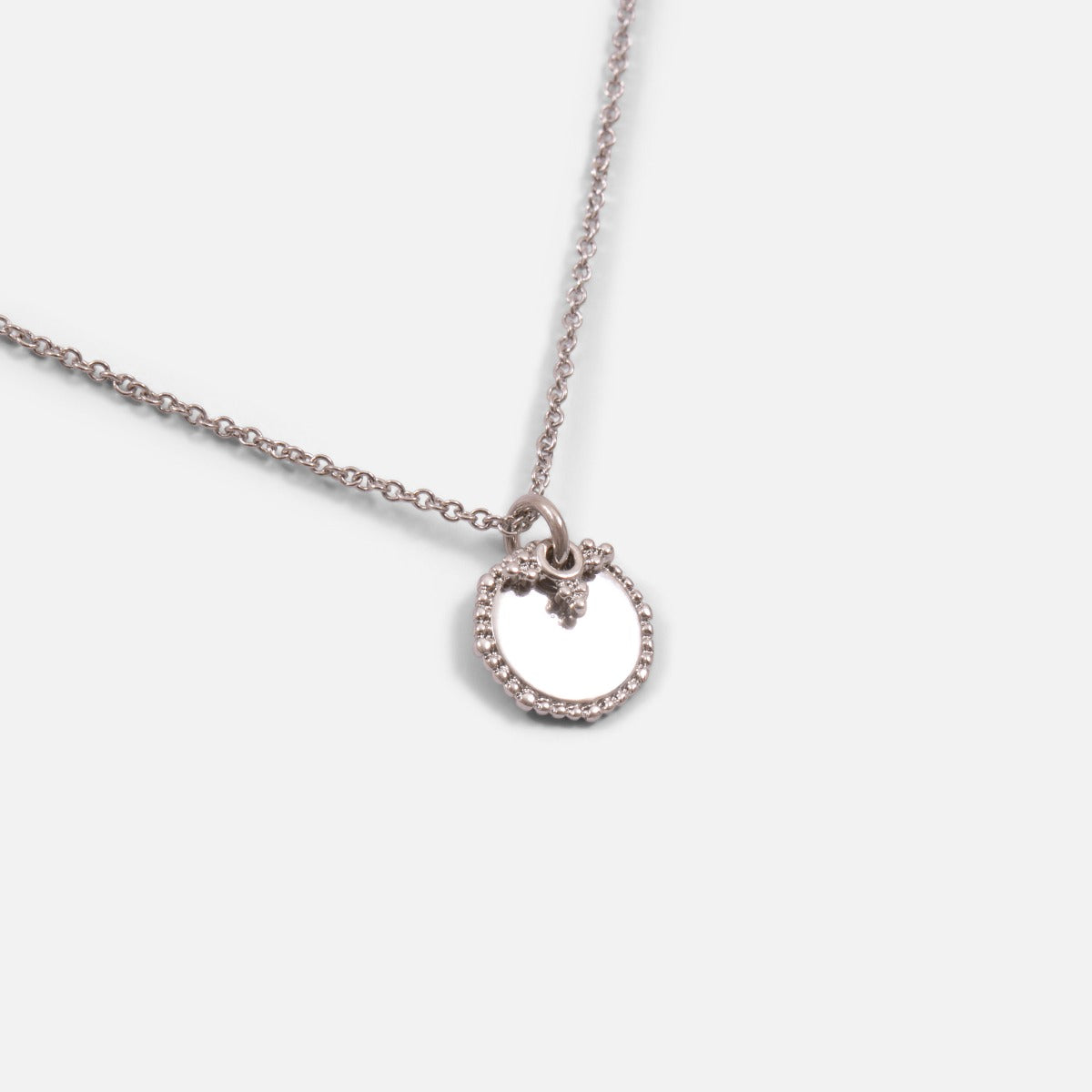 Pendant with circle charm and silvered pearl beads
