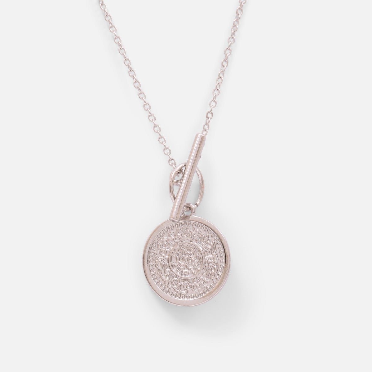 Silvered pendant with a coin charm and a round clasp and  bar