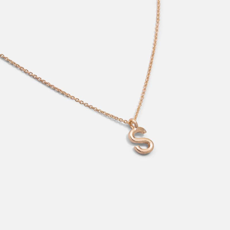 Golden pendant with letter s charm