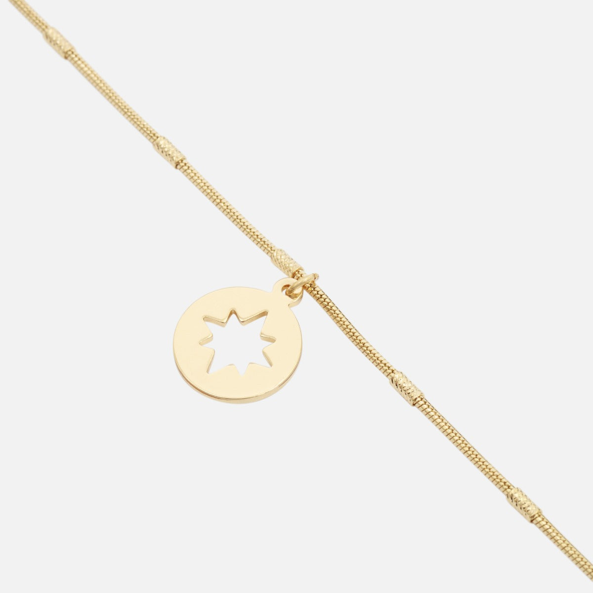 Golden ankle chain with star medallion