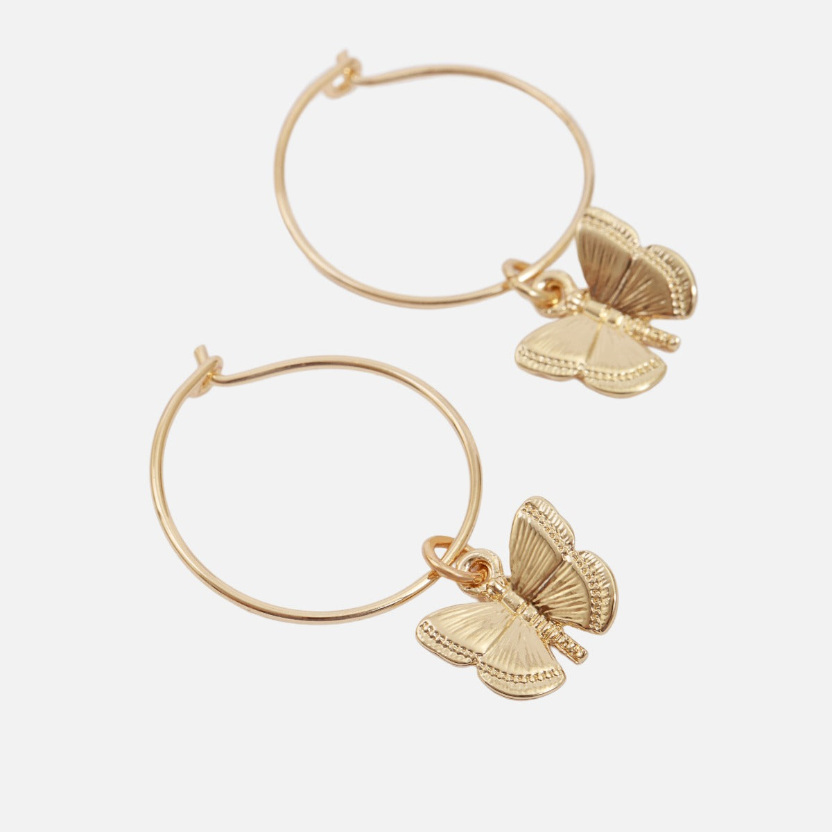Set of golden fixed earrings and butterfly hoops