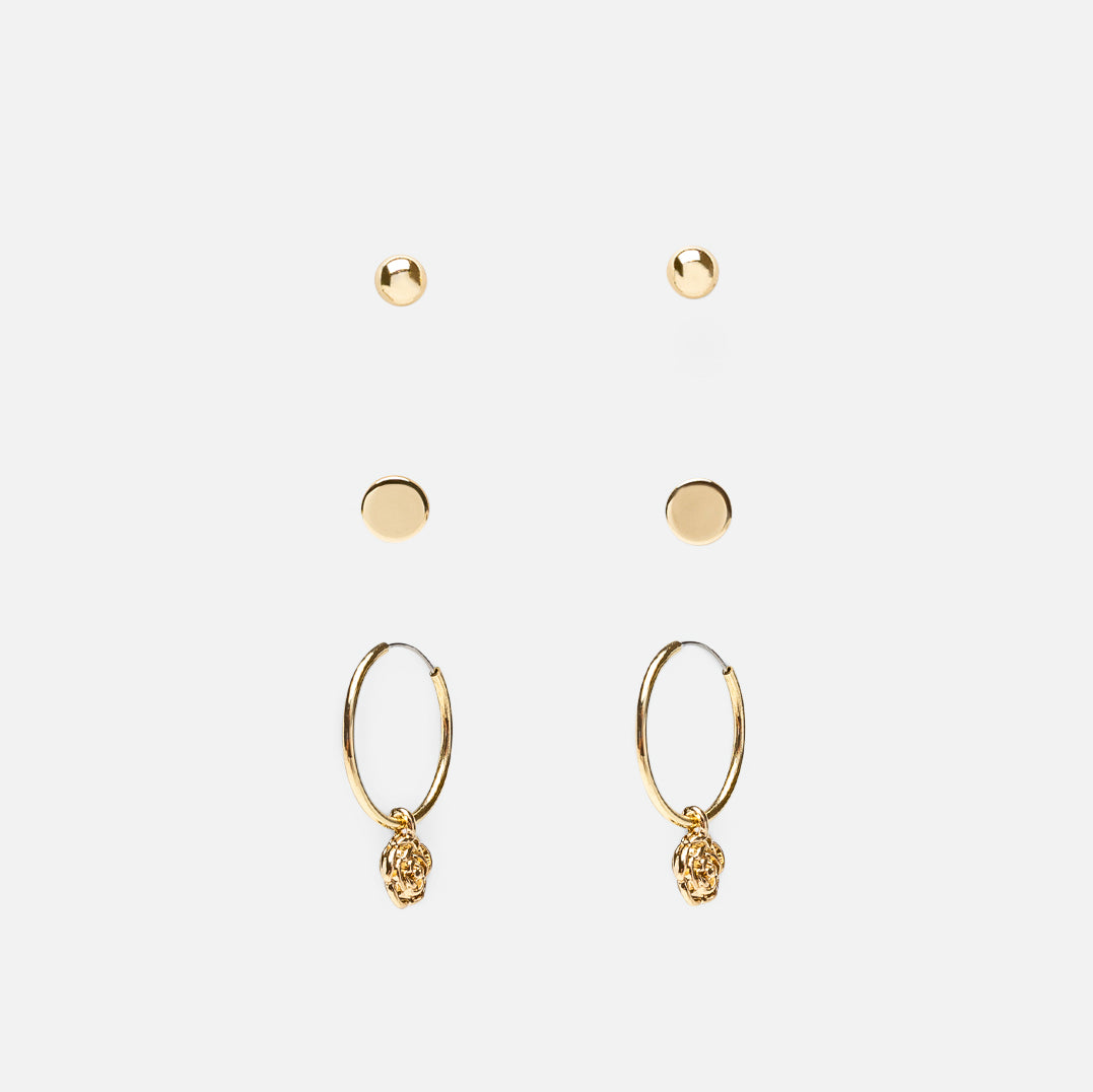 Set of three golden fixed earrings and hoops with flower charm