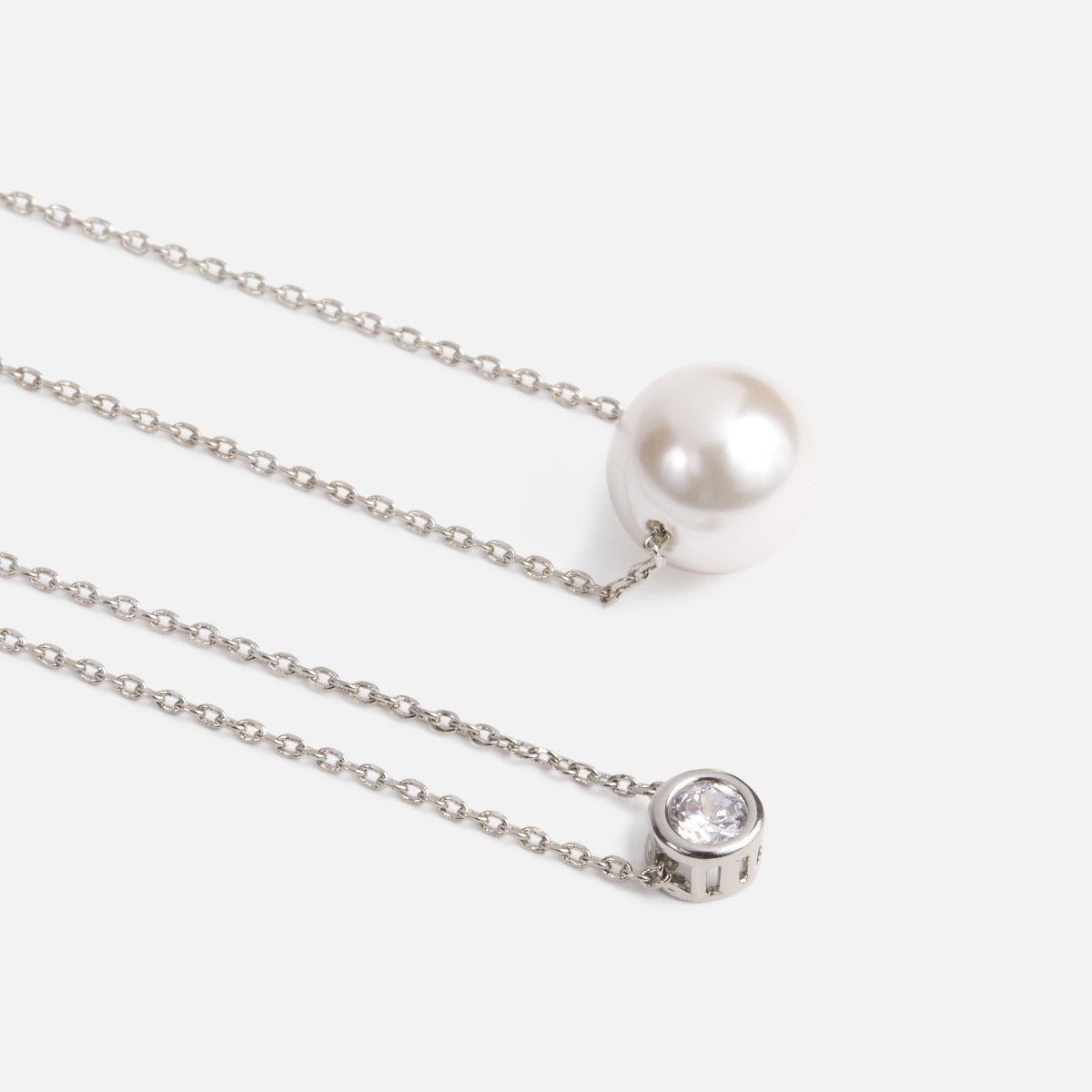 Set of two necklaces with pearl and glittering stone   