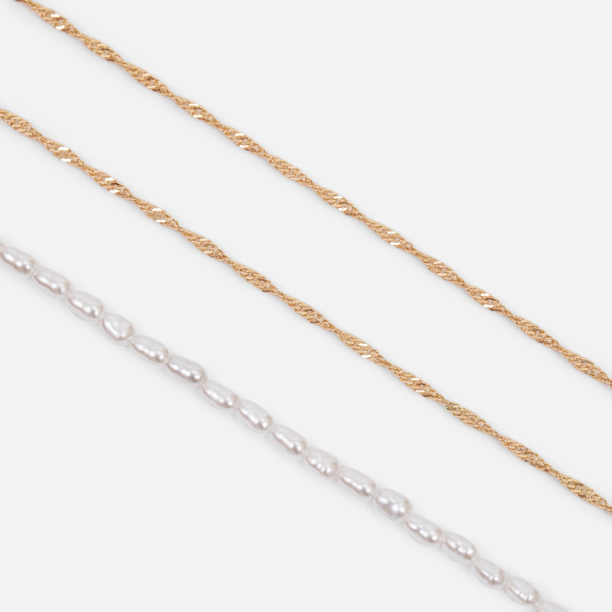Ensemble de trois bracelets dorés double chaînes singapour et perles