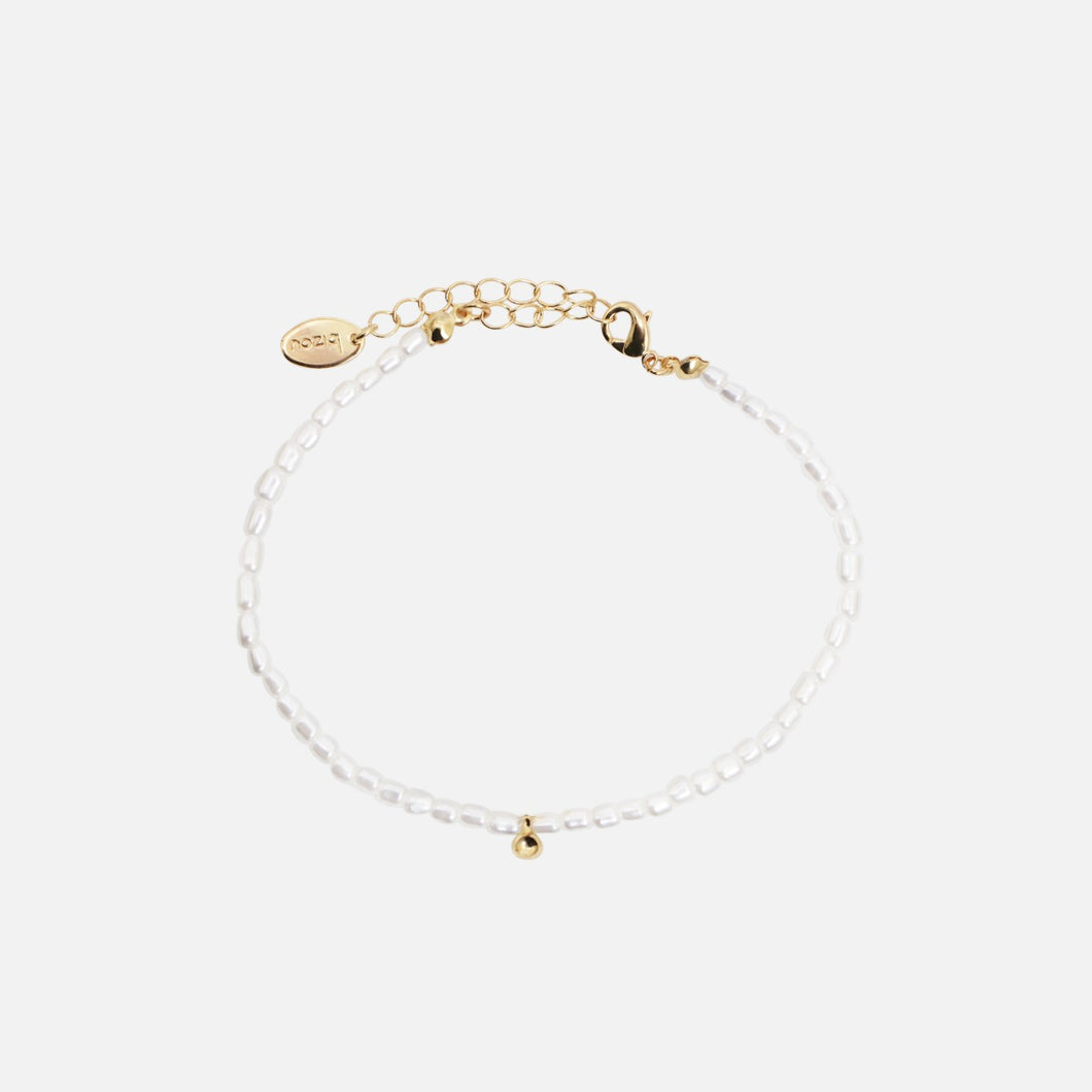 Tiny ankle chain with small white pearls and golden ball charm