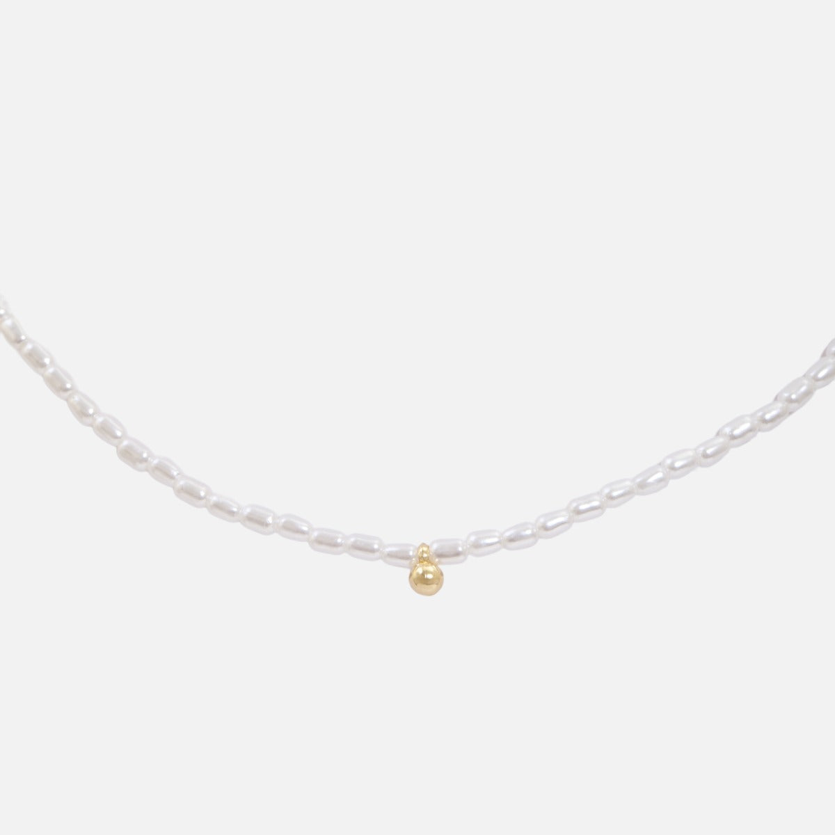 Tiny necklace with small white pearls and golden ball charm