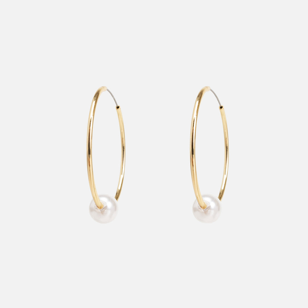 Golden hoop earrings with pearl insert