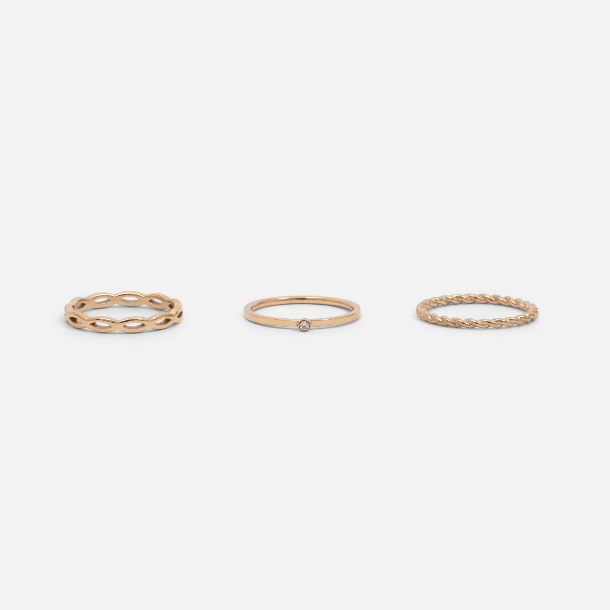 Set of three golden stainless steel wave, twist and zirconium rings 