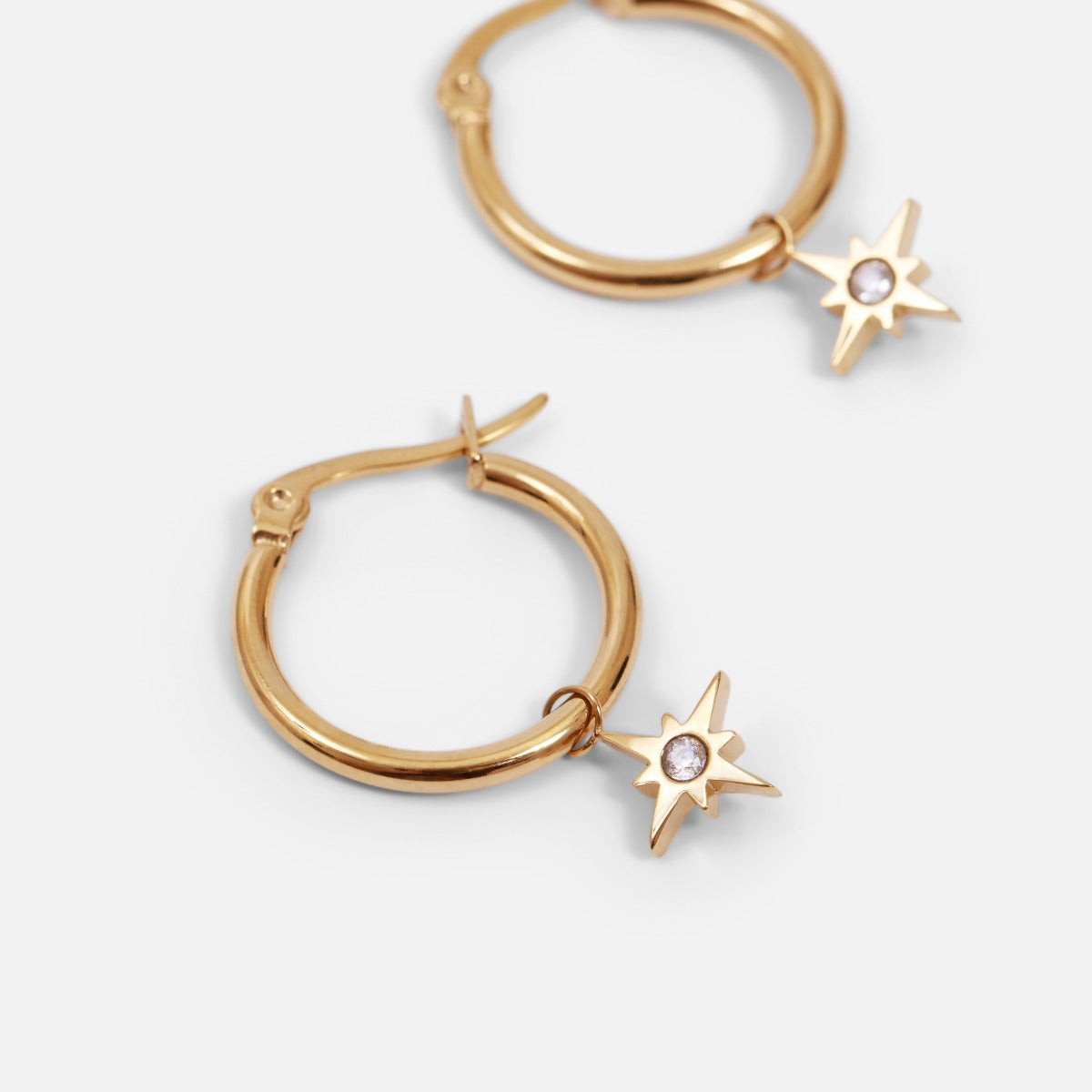 Golden earrings with star charm in stainless steel