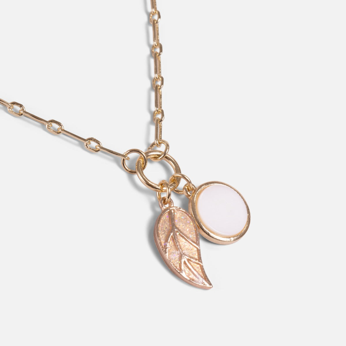 Golden pendant with leaf and circle charms