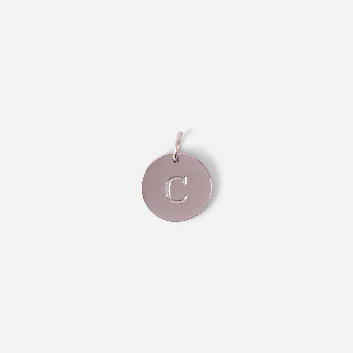 Small symbolic silvered charm engraved with the letter of the alphabet "c"