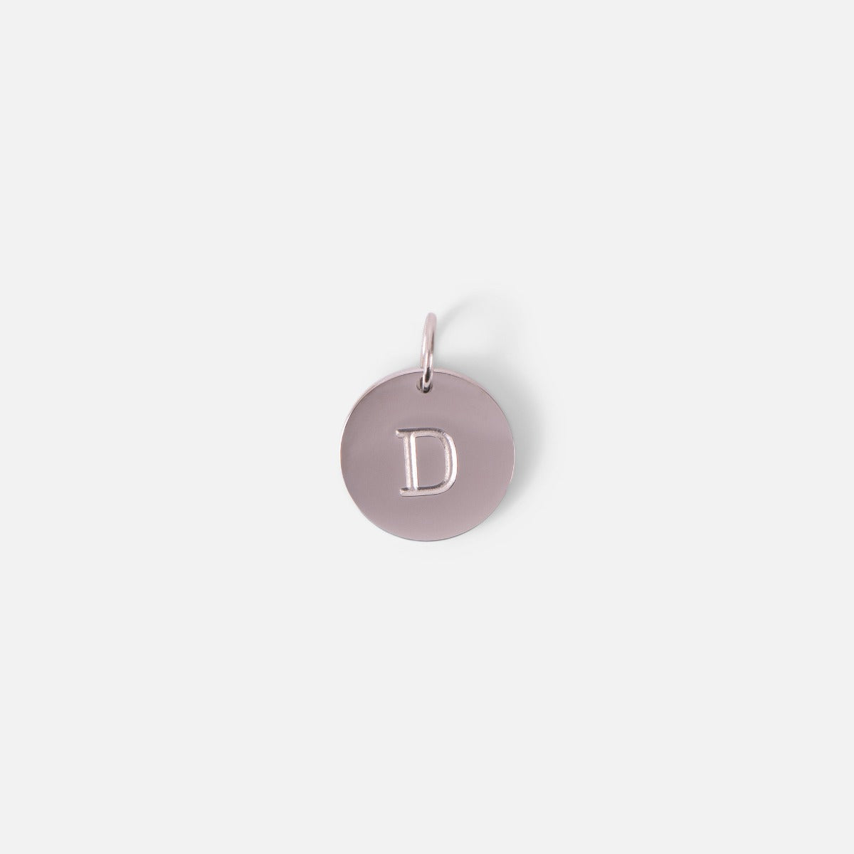 Small symbolic silvered charm engraved with the letter of the alphabet "d"
