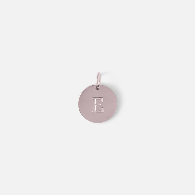 Small symbolic silvered charm engraved with the letter of the alphabet "e"