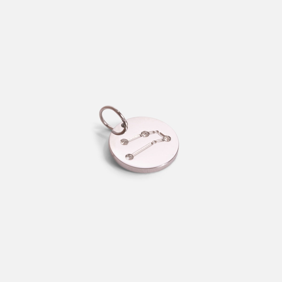 Small silvered charm engraved with the zodiac constellation "gemini"