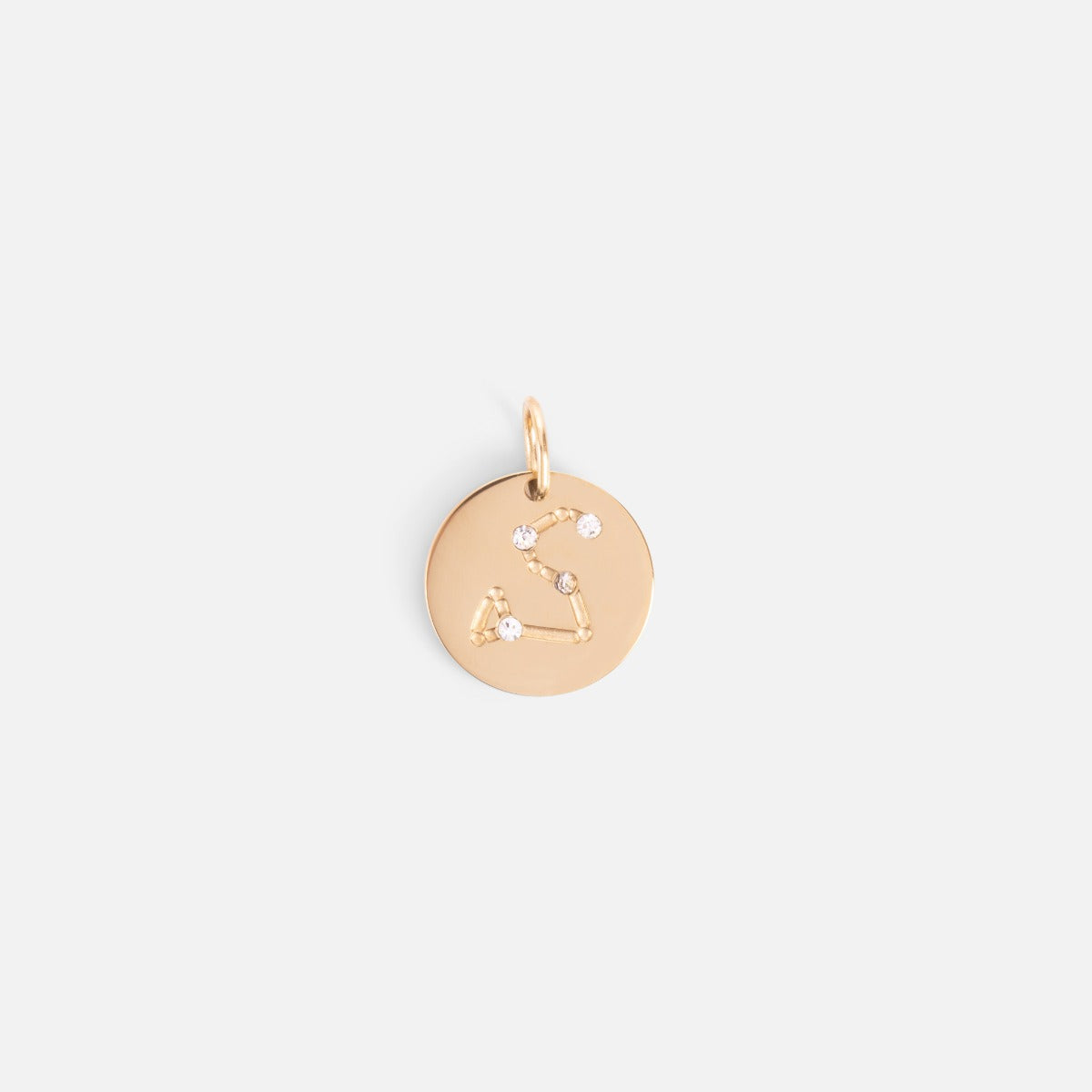 Small golden charm engraved with the zodiac constellation "leo"
