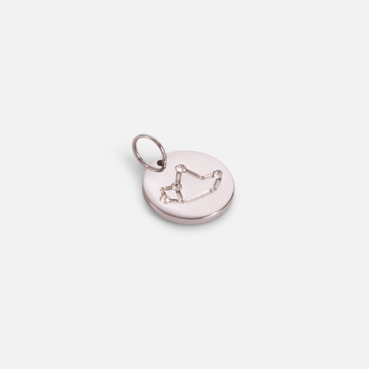 Small silvered charm engraved with the zodiac constellation "sagittarius"