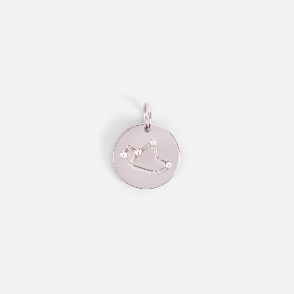 Small silvered charm engraved with the zodiac constellation "sagittarius"