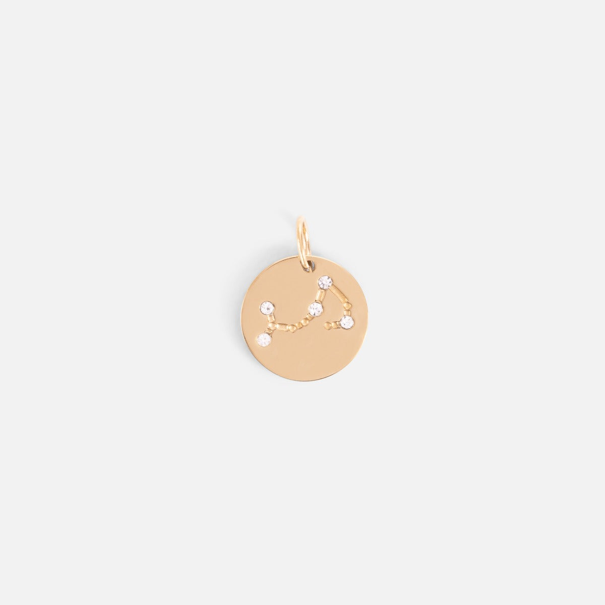 Small golden charm engraved with the zodiac constellation "scorpio"