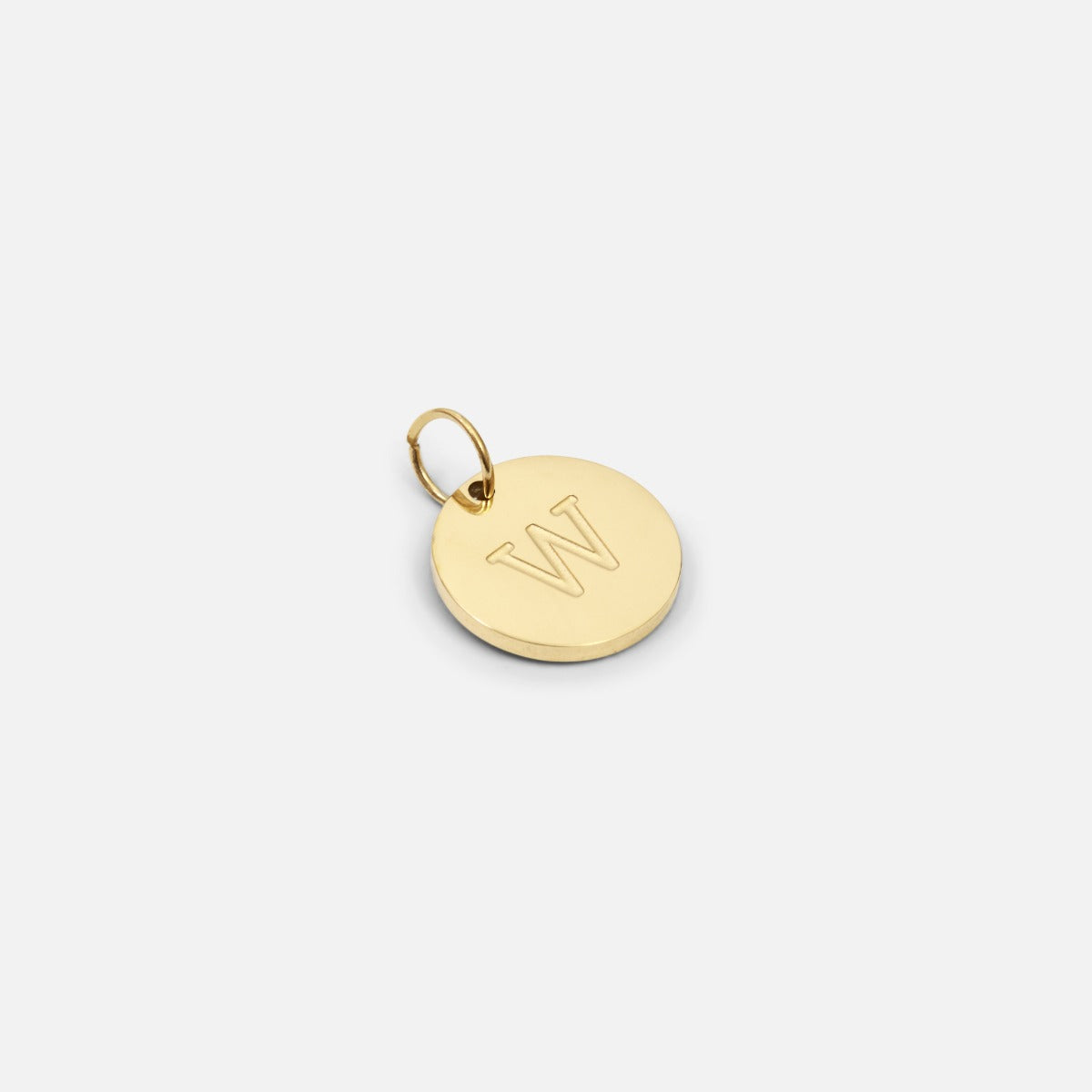 Small symbolic golden charm engraved with the letter of the alphabet "w"