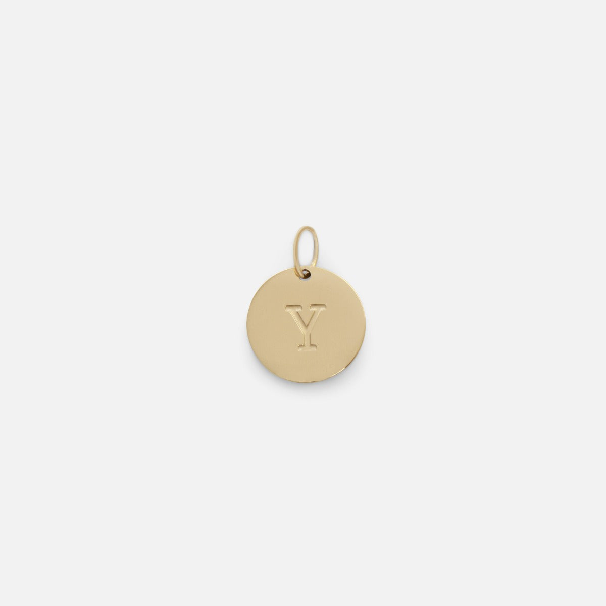 Small symbolic golden charm engraved with the letter of the alphabet "y"