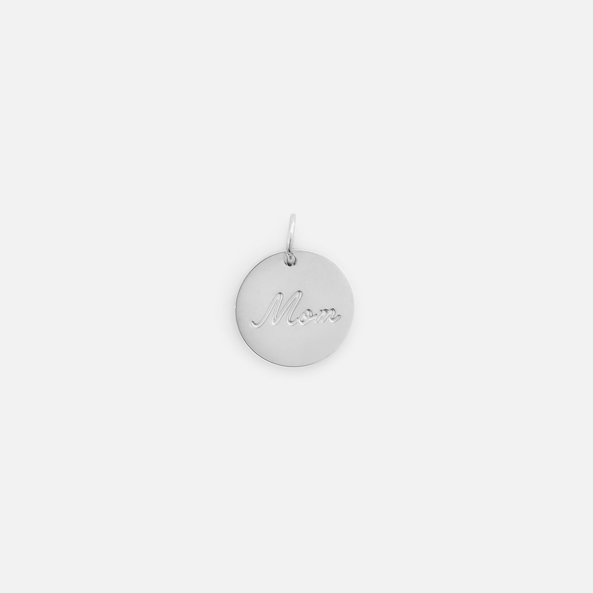 Small symbolic silvered charm engraved "mom" wording