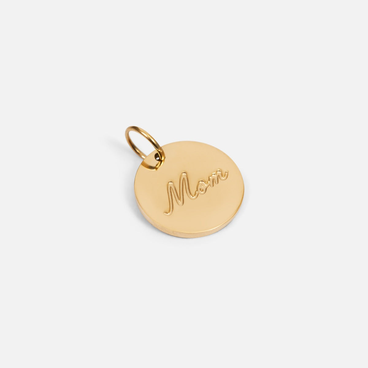 Small symbolic golden charm engraved "mom" wording