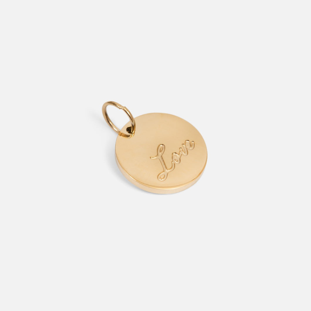 Small symbolic golden charm engraved 