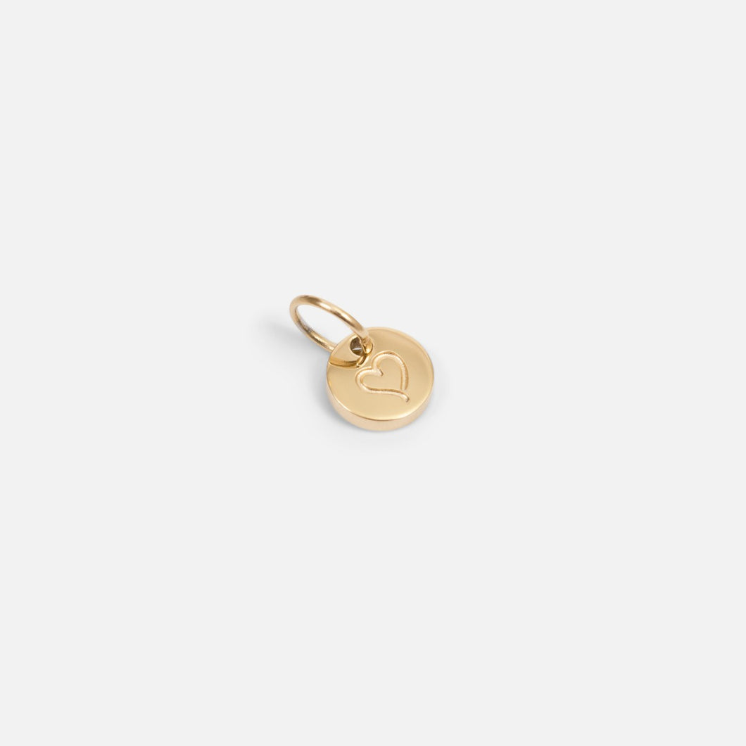 Small symbolic golden charm engraved 