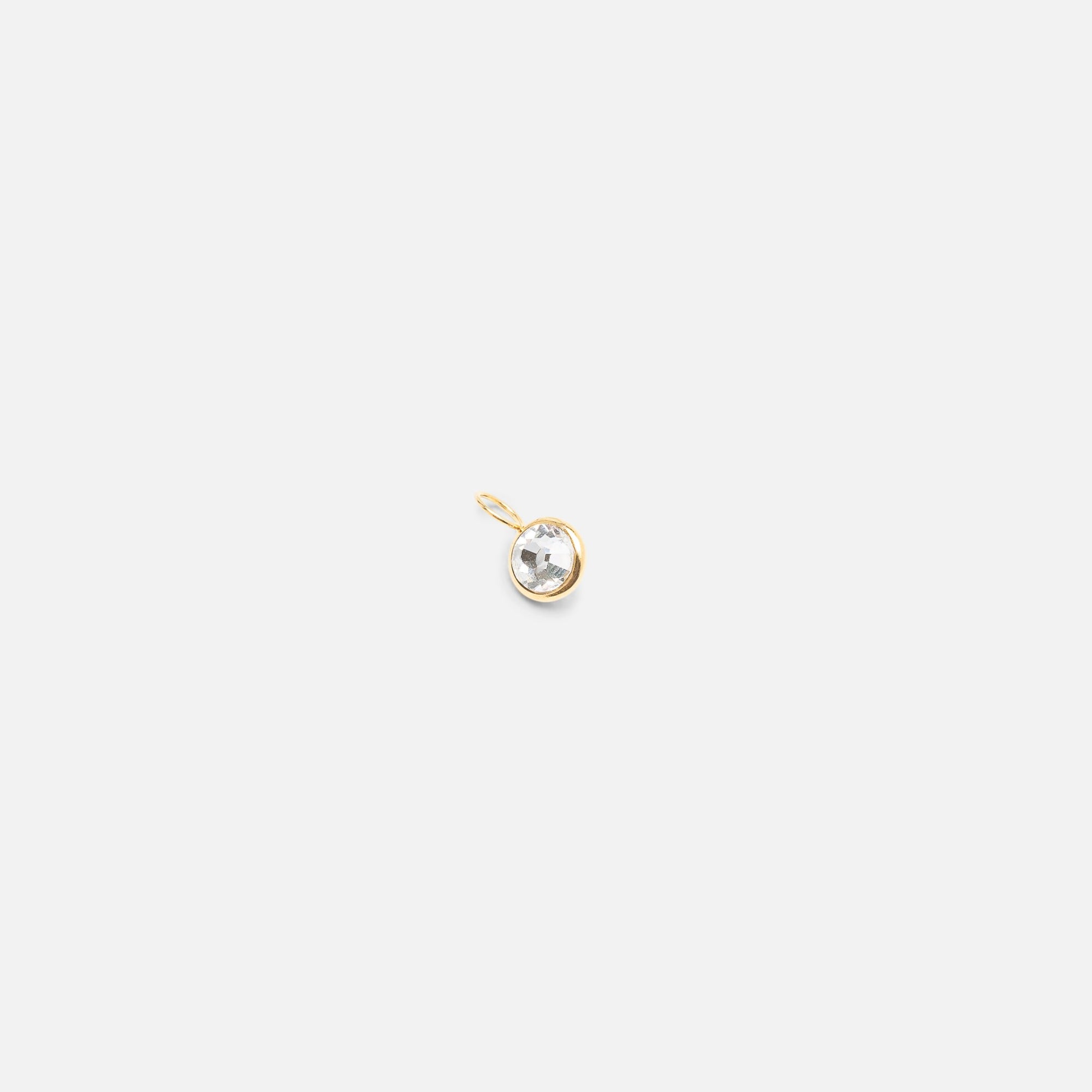 Small golden charm with cubic zirconia