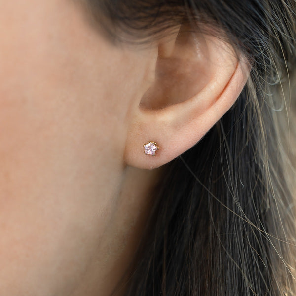 Load image into Gallery viewer, Mini 3mm golden earrings with a pink zirconia stone with a flower-shaped
