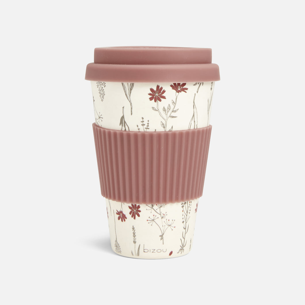 Coffee cup in floral pattern with old pink silicone sleeve and lid