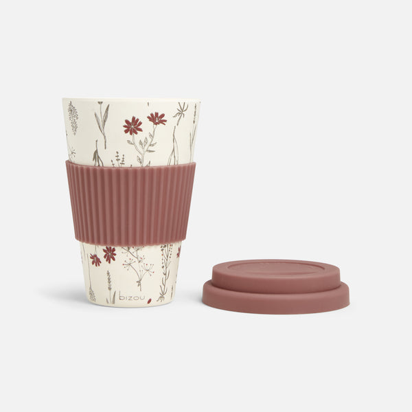 Load image into Gallery viewer, Coffee cup in floral pattern with old pink silicone sleeve and lid
