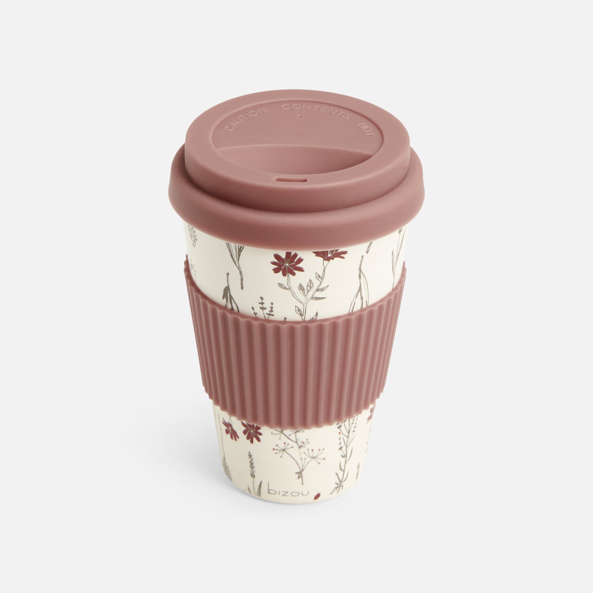 Coffee cup in floral pattern with old pink silicone sleeve and lid