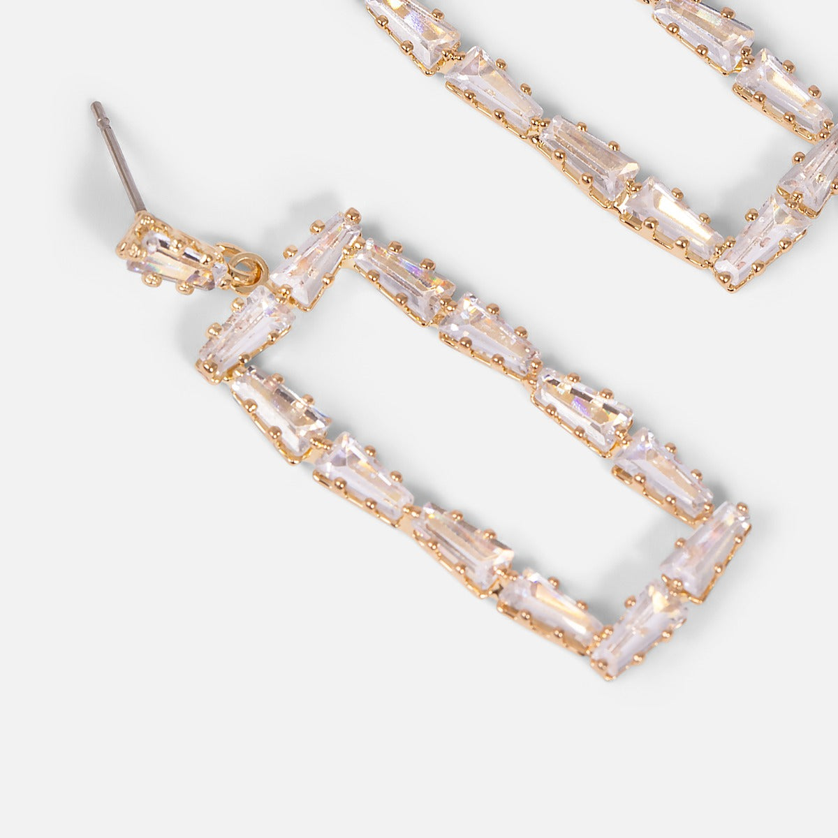 Long golden earrings in rectangular shape with stones